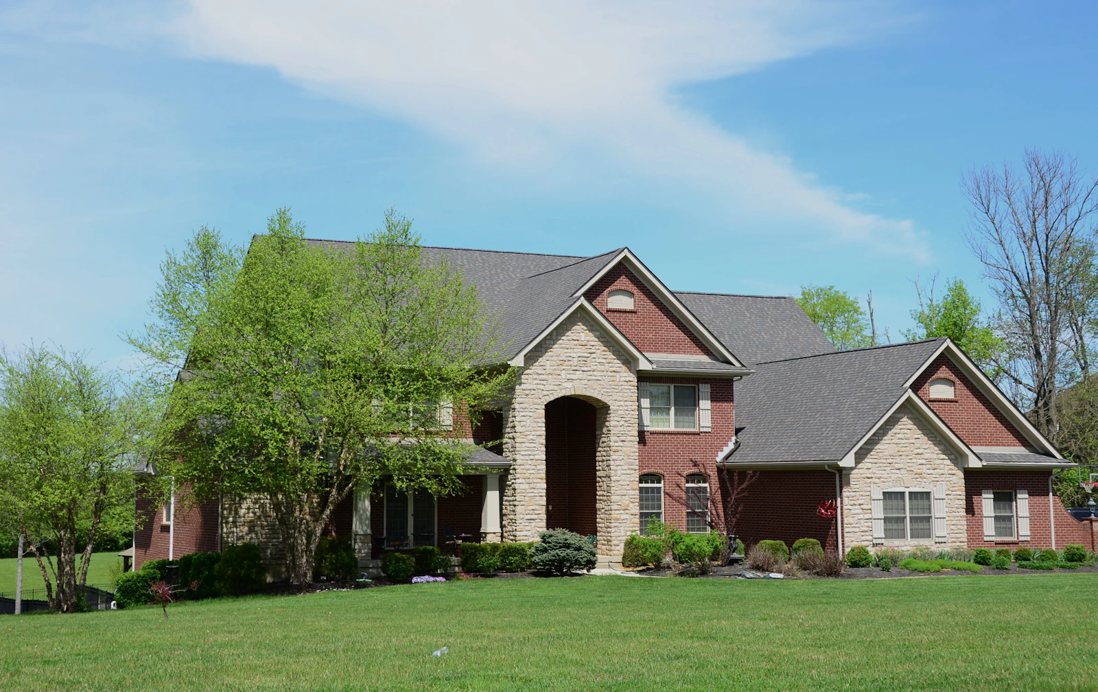 A large home with a lush, freshly mowed green lawn